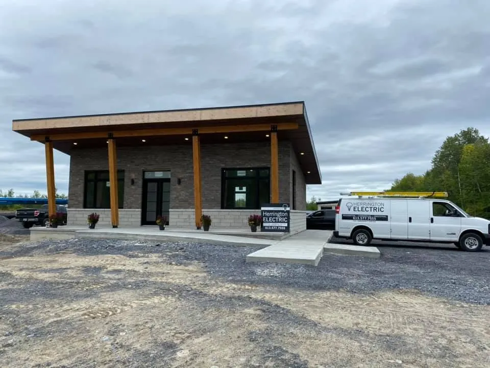 Completed commercial building exterior with a Herrington Electric service van.