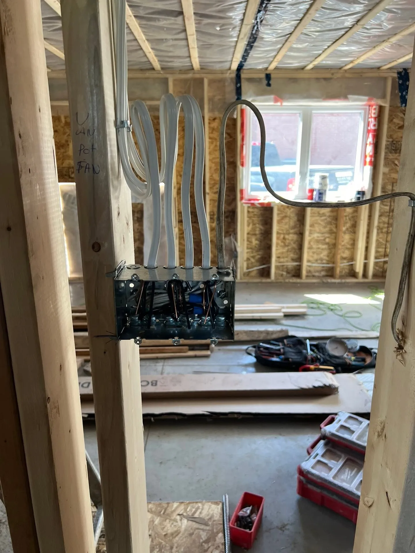 Electrical cables and boxes roughed into the framed walls of a new home.