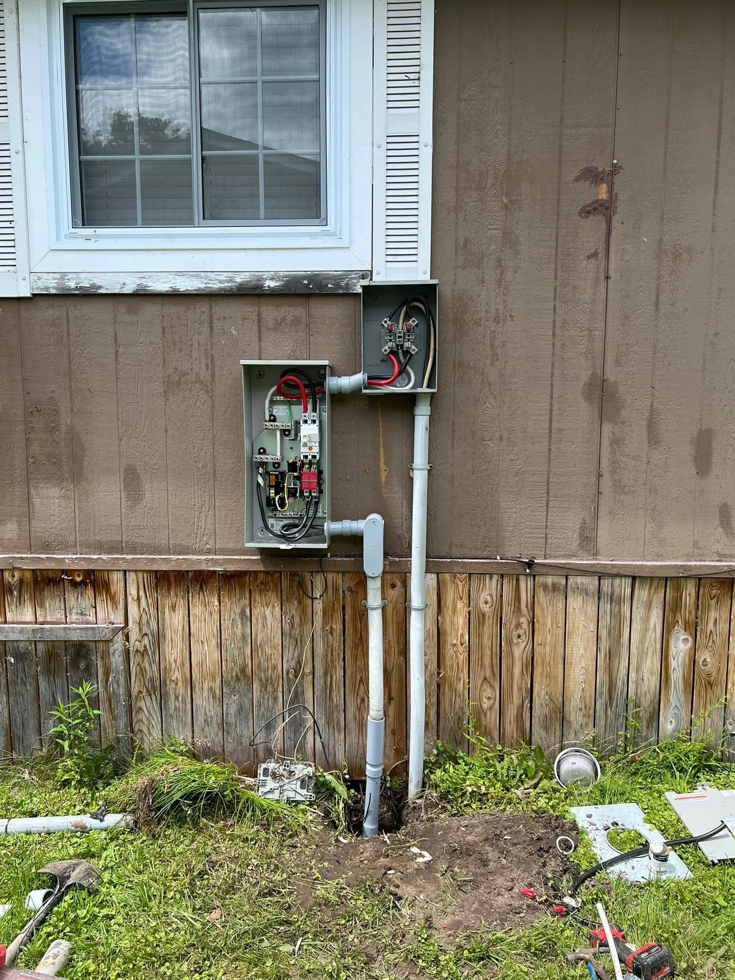Open residential meter base and service conduit during an electrical upgrade.