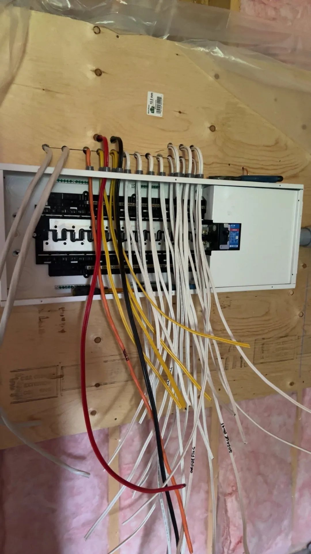 Branch circuits routed into a residential breaker panel during new construction.